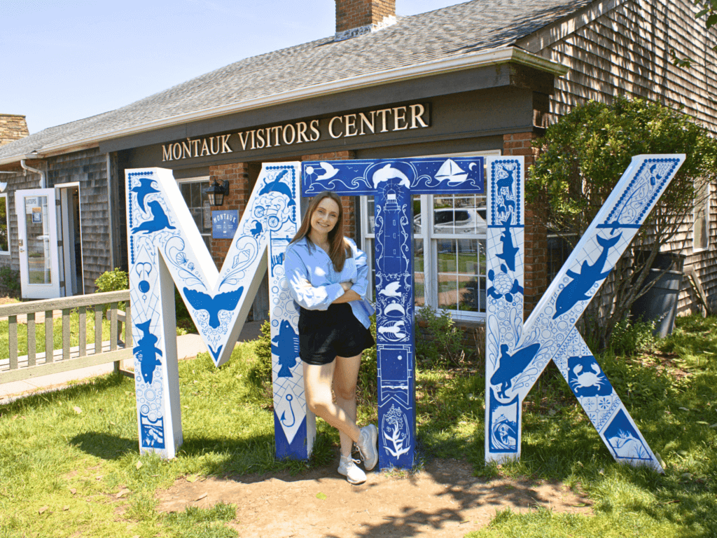 Sarah Schreck poses next to her redesigned “MTK” sign, May 2024
