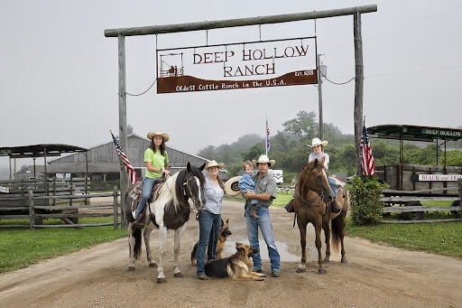 The Keogh family pose under the Deep Hollow Ranch sign.