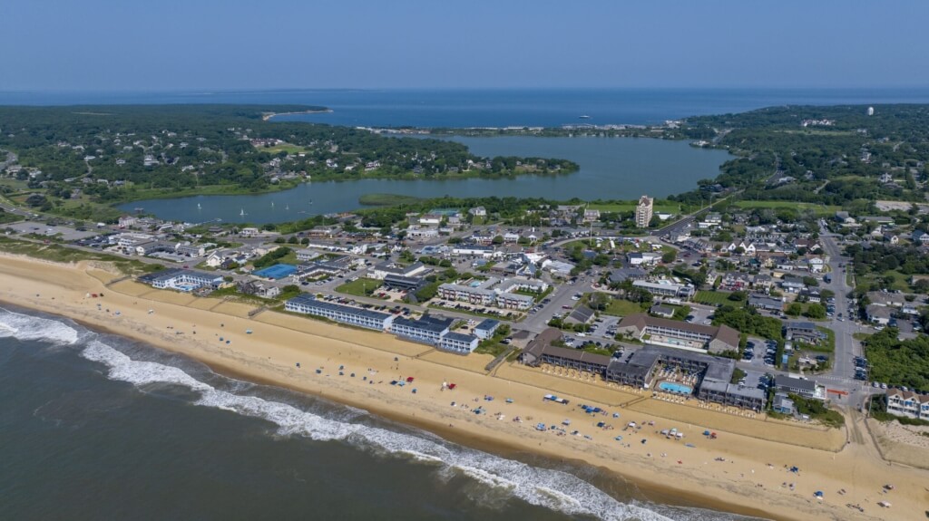 Drone aerial view of Downtown Montauk from the ocean, including Fort Pond and Fort Pond Bay