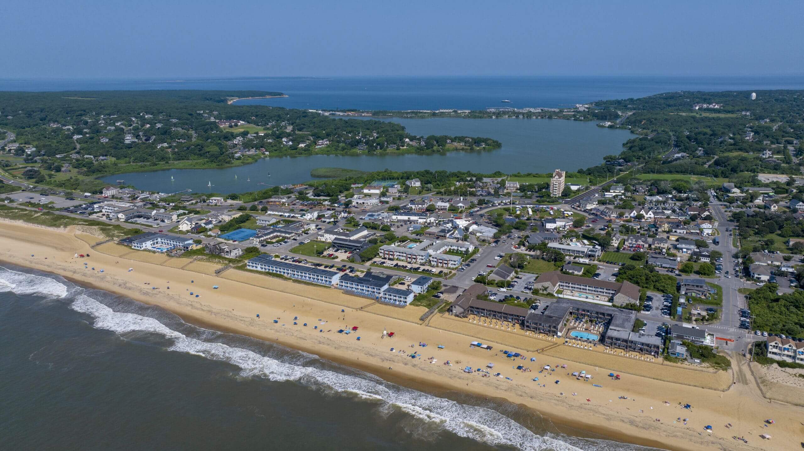Drone aerial view of Downtown Montauk from the ocean, including Fort Pond and Fort Pond Bay