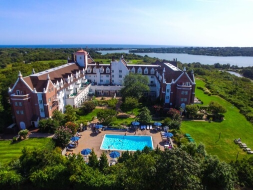 'Montauk Manor aerial photograph with outdoor pool, Fort Pond, and ocean views