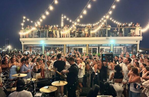 'A crowded dance floor in front of a live band at Salivar's in Montauk