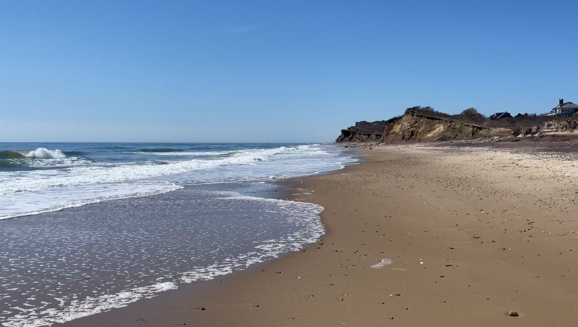 Clear blue sky, empty beach at Ditch Plains Beach under the bluffs, Spring 2024