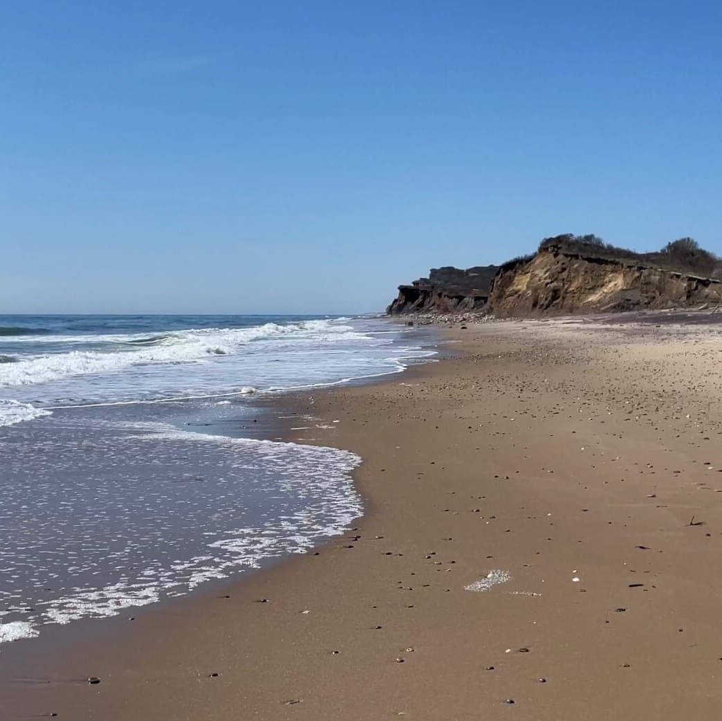 Clear blue sky, empty beach at Ditch Plains Beach under the bluffs, Spring 2024