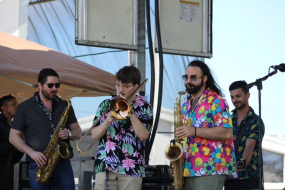 Brass musicians of Firetog & Co. perform in Hawaiian shirts during the 2025 Montauk Music Festival on Town Green