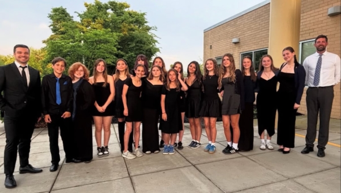 Montauk Public School's SoundWaves musical group with choral director, Jake Lorefice (left) and superintendent, Josh Odom (right)